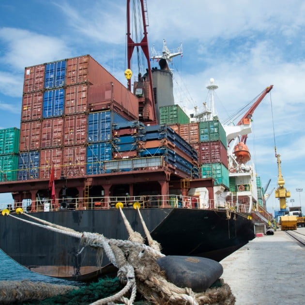 Docked cargo vessel loaded with multicolored shipping containers, representing Malaysia’s seaborne exports and trade links with China.