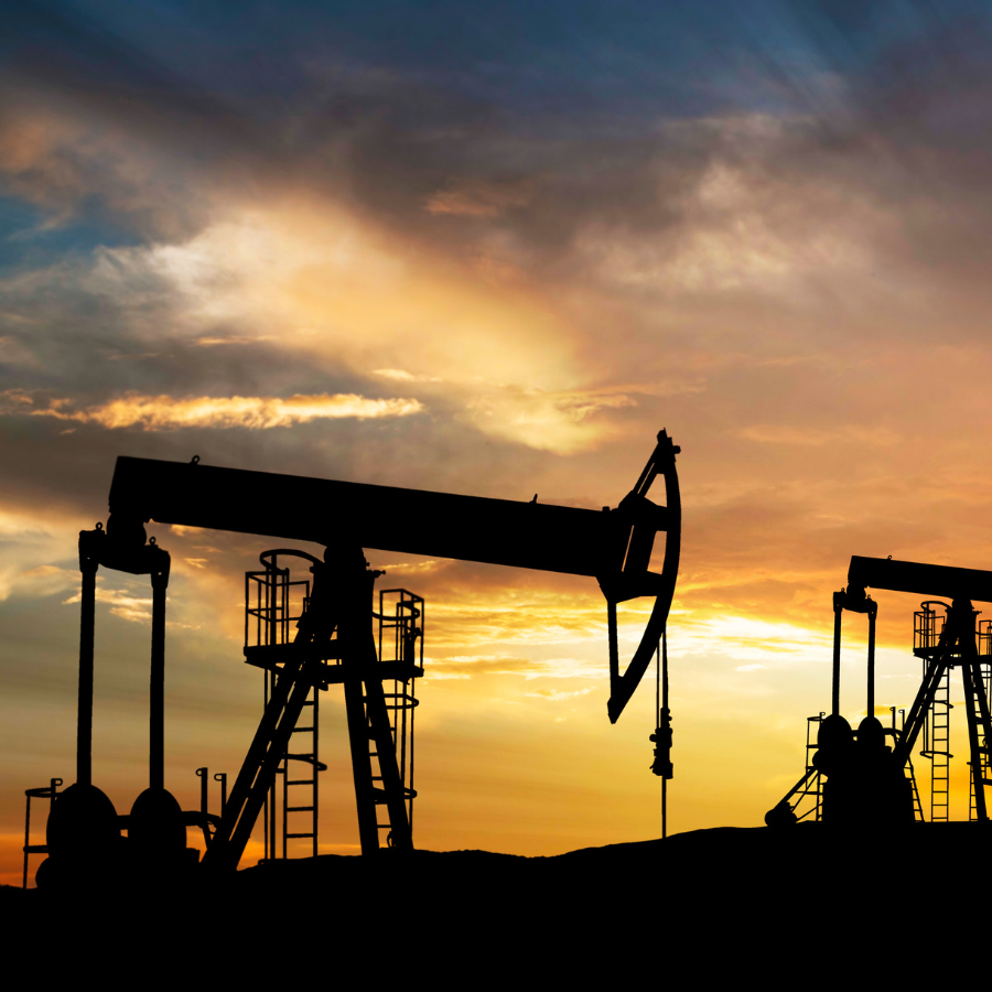 Pump jacks silhouetted against the sunset, symbolizing Malaysia’s upstream natural gas production.